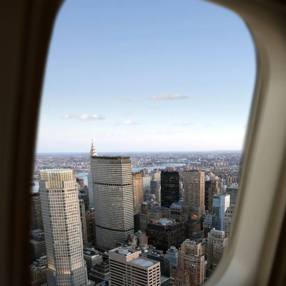 A view of buildings and skyscrapers from the airplane window.