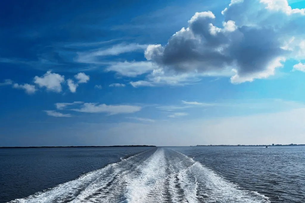 Watching the waves and sky from the upper deck of a water taxi.