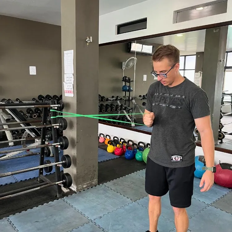 Warming up before a workout with a stretching band at Belize Fitness in San Pedro.